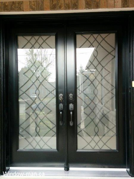 Double front entry steel insulated exterior doors. Black. Oak Ridge wrought iron glass inserts